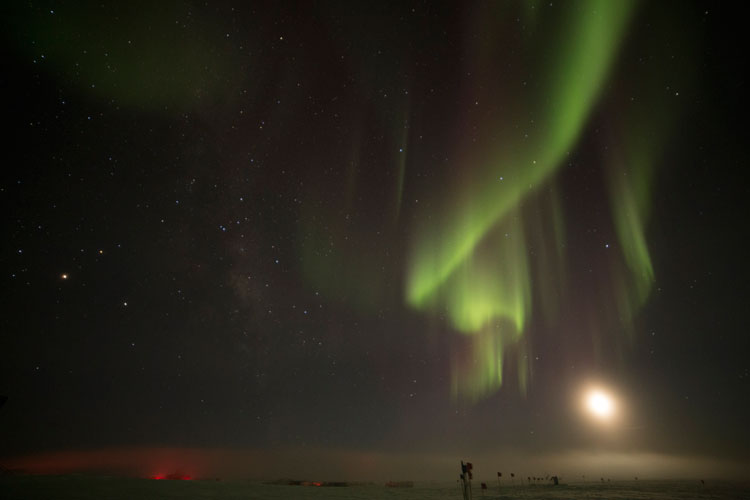 bright moon competing with aurora