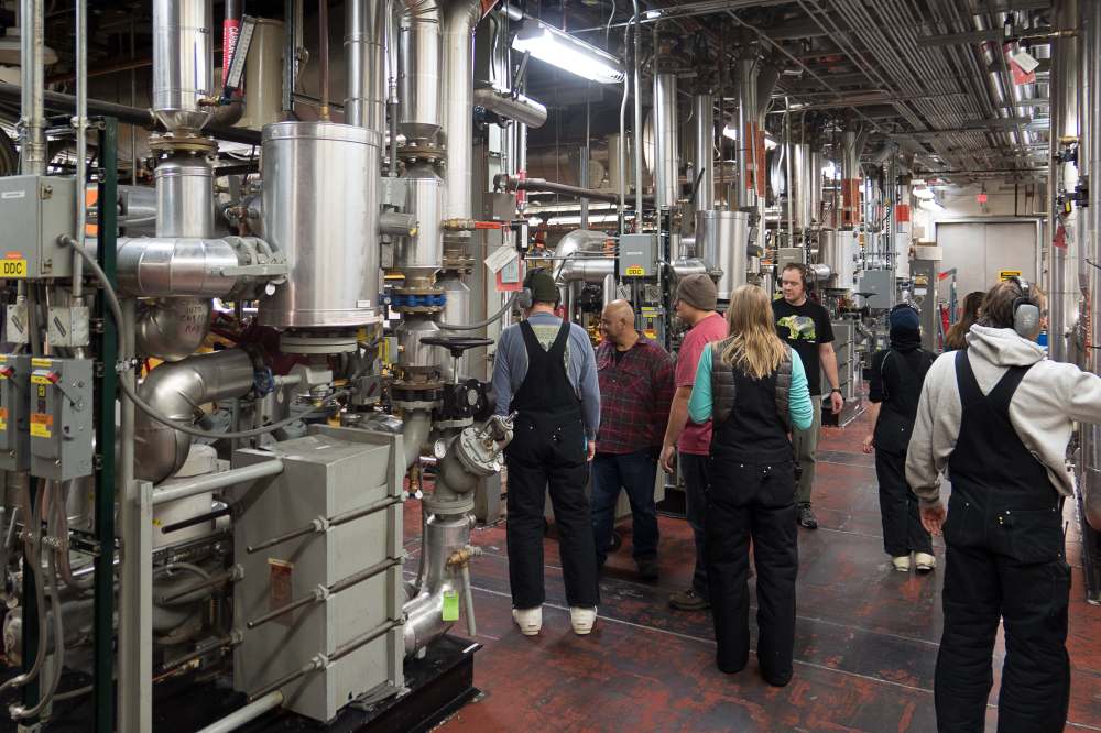 Several individuals shown inside power plant room