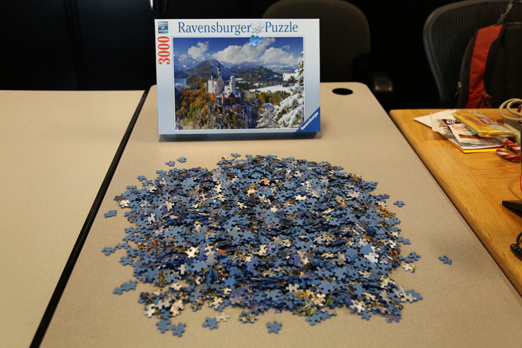 jigsaw puzzle pieces in pile on table