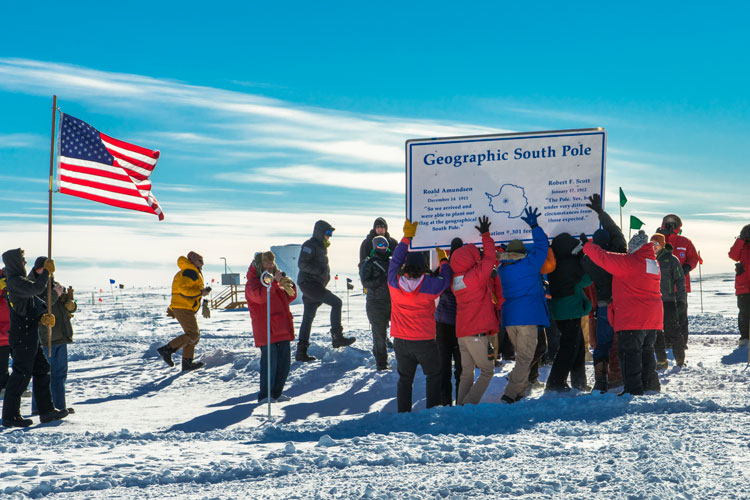Group erecting sign for geographic South Pole