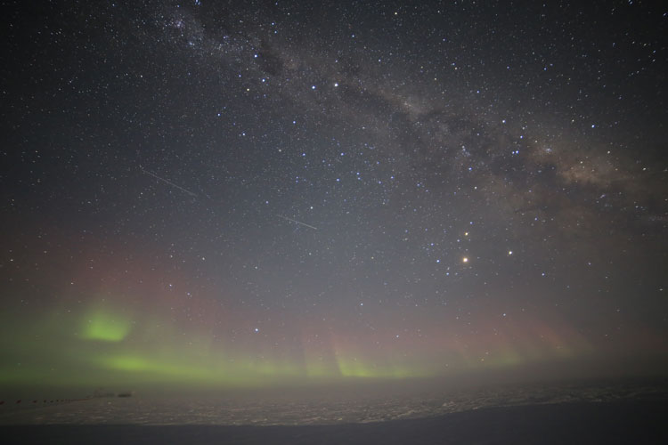 starry South Pole sky with auroras