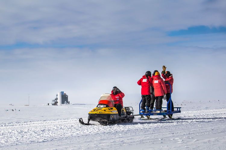 snowmobiling at the South Pole, with ICL in background