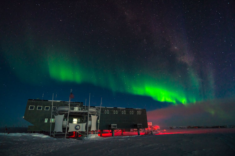 South Pole station with bright horizontal aurora