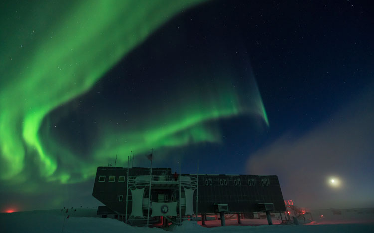 South Pole station with large swirly aurora
