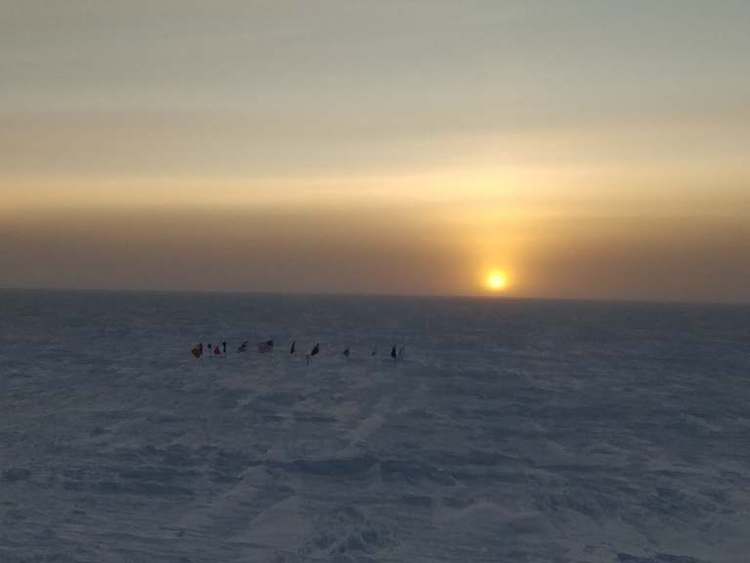 Sun rising over ceremonial South Pole