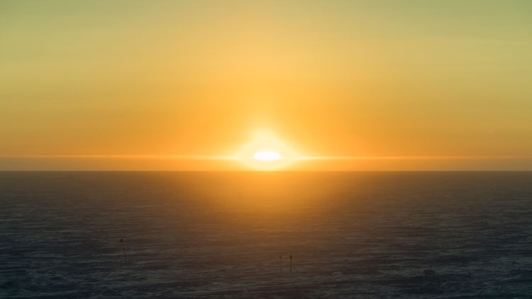 sun rising over horizon at South Pole