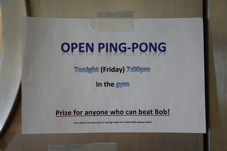 Sign taped to wall about ping pong contest