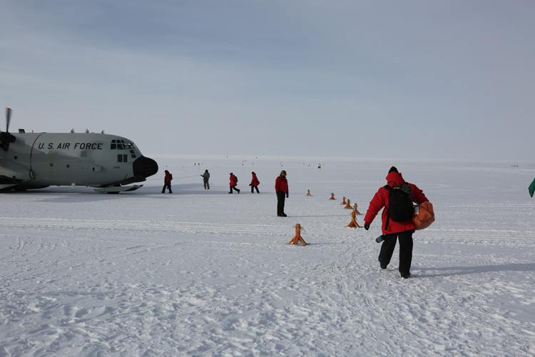 Folks walking toward plane, departing South Pole