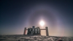The IceCube Lab with bright moon and lunar halo as backdrop